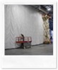 For tall curtains, a man lift is used to fasten the curtain to the ceiling.