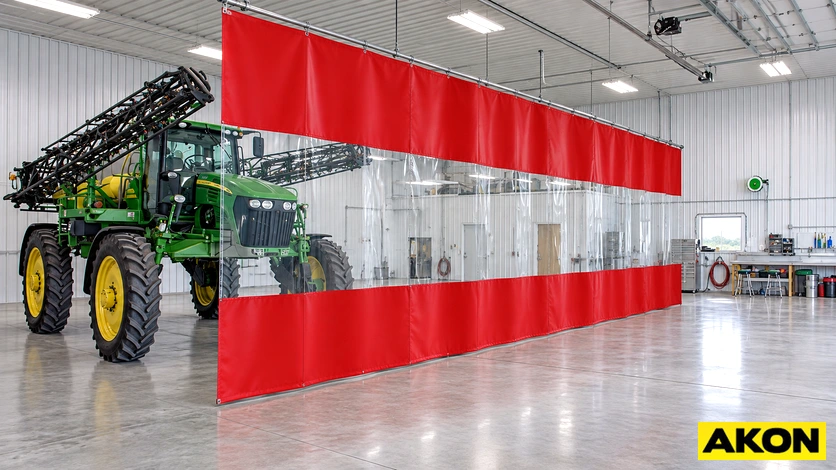 Large fabric divider curtains installed inside a barn to separate interior sections.