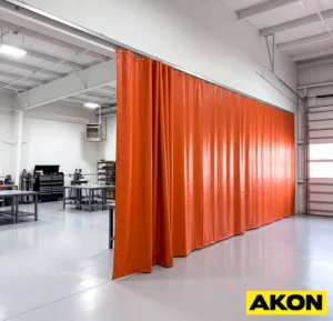 Flame retardant industrial vinyl curtain hanging in a commercial or manufacturing facility as a partition.