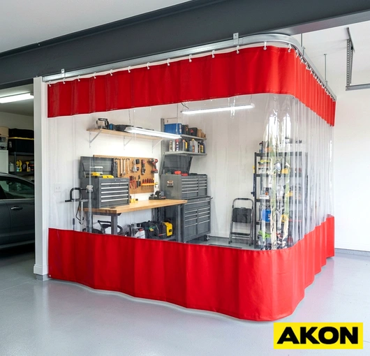 Heavy-duty curtains enclosing a garage bay to separate the interior workspace from the outside.