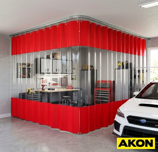Heavy-duty curtains enclosing a garage bay to separate work areas and contain temperature, dust, and noise.