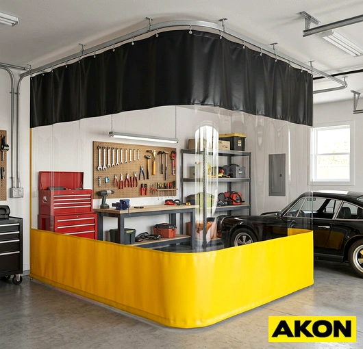 Heavy-duty curtains enclosing a garage bay to separate work areas and control environmental conditions.