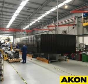 Amber welding strip curtains hanging in an industrial facility to contain sparks and shield workers from arc flash.
