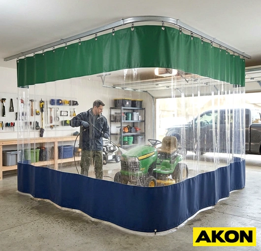 Heavy-duty vinyl curtains installed in a commercial garage wash bay to contain water and separate work areas.