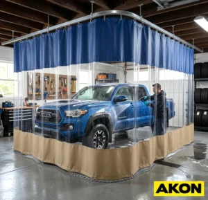 Heavy-duty vinyl curtains installed in a commercial garage wash bay to contain water and overspray.