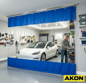 A heavy-duty fabric divider curtain installed across a garage interior to separate working zones.