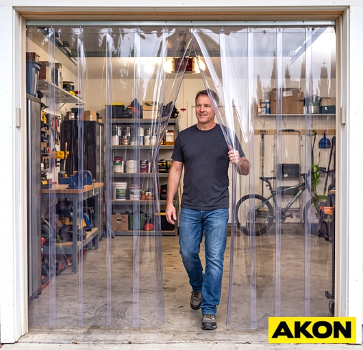 Durable PVC vinyl strip curtains hanging in an industrial doorway to separate work areas.