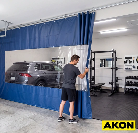 Heavy-duty curtain dividers installed in a garage gym to separate workout zones.