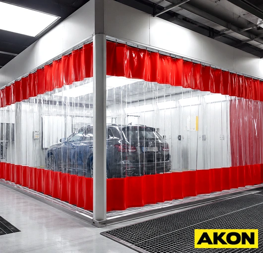 Heavy duty curtain panels configured as a prep booth enclosure in an industrial facility.