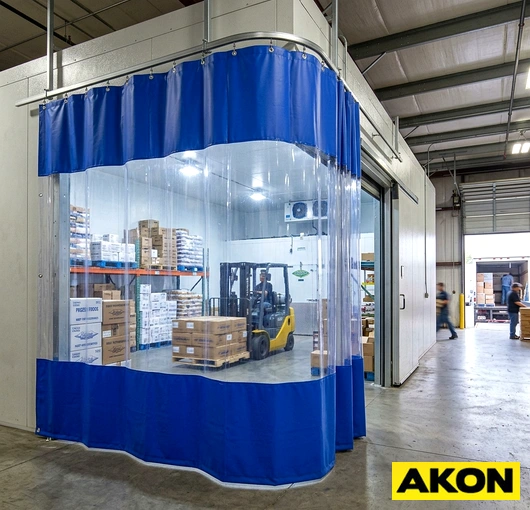 Commercial isolation curtains installed in an industrial or commercial facility to separate work areas and control environmental conditions.