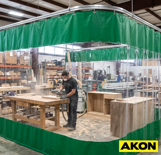 Commercial protective isolation curtains dividing a work area in an industrial or commercial facility.
