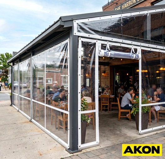 Clear vinyl awning side panels installed on an outdoor structure, blocking wind and weather while maintaining visibility.