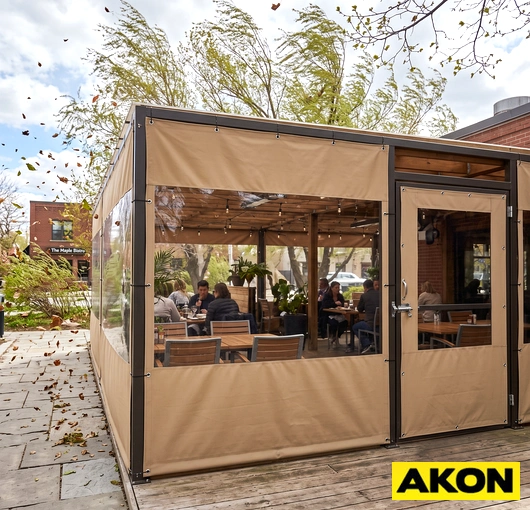 Clear tarp panels installed as a wind barrier on an open outdoor or semi-enclosed industrial space.