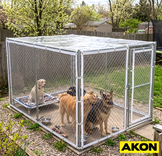 Vinyl side panel covers installed on an outdoor dog kennel to block wind and weather.