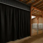 Climate control in barns and animal facilities using black industrial curtain walls inside a modern livestock barn with metal stalls and wooden beams