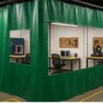 Green vinyl Makerspaces and Hackerspaces curtains creating a dedicated work zone inside an industrial-style workshop for flexible space division and privacy