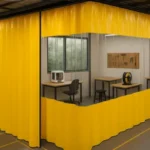 Makerspaces and hackerspaces curtains enclosing a dedicated workspace with workbenches, tools, and 3D printers for organized project areas