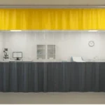 Medical lab divided by industrial curtain walls with yellow, clear, and dark gray panels, showing lab equipment, exam table