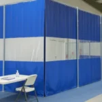 Pop-Up medical labs, testing stations, and isolation areas with curtain walls featuring blue and clear panels, folding tables, chairs, and sanitation supplies