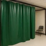 Pop-Up medical labs, testing stations, and isolation areas with curtain walls featuring green vinyl panels in a private enclosed frame with seating and entry door