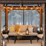 Black-framed gazebo enclosed with clear PVC panels and string lights in snowy backyard Convert a Gazebo to a Cozy Winter Room with Removable PVC Panels