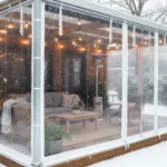 Clear vinyl patio enclosure on a louvered pergola in snowy backyard – Winterizing a Louvered Pergola – What Works and What to Avoid