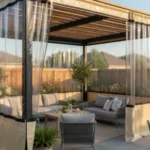 Clear vinyl pergola enclosure with tan trim showcasing outdoor seating area – Pergola Enclosures vs. Permanent Walls – Flexibility and Resale Value