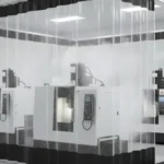 Coolant Spray Containment Solutions for Machining Zones Without a Top Rail using clear vinyl curtain walls with red and black panels