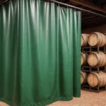 Curtain Walls for Wine Cellars or Barrel Aging Rooms in Shared Warehouses with green dividers separating stacked wooden wine barrels, ideal for micro-wineries and hobby vintners
