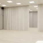 How dance studios use curtain walls for private lessons or auditions, where beige dividers provide separation for individual training areas