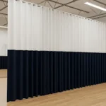 How dance studios use curtain walls for private lessons or auditions, with white and navy panels forming private practice zones inside the studio