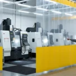 Industrial Coolant Spray Containment Solutions for Machining Zones Without a Top Rail using modular red and clear curtain walls