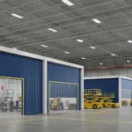 Industrial curtain walls for airport maintenance hangars and staging areas, with blue fabric dividers enclosing aircraft and work zones