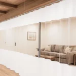 Industrial curtains for dividing large Airbnb properties or group lodges, featuring white fabric with clear panels to create private rental spaces and show how to divide shared rental space effectively
