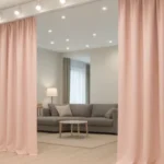 Industrial curtains for dividing large Airbnb properties or group lodges, with pale pink fabric creating private lounge and communal living areas in shared rental spaces