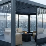Modern pergola enclosed with Roll-up Clear Patio Curtains – Keep Your View in Winter, offering clear views and protection during snowfall