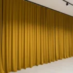 Retail showroom curtains in beige providing full wall coverage for a clean and elegant store layout