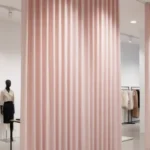 Retail showroom curtains in soft pink adding color and privacy to modern boutique fitting areas