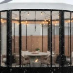 Round pergola with black framed vinyl side panels used as a winter enclosure – Pergola Side Panels Temporary Winter Solutions That Look Built-In