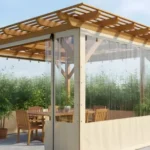 Small wooden pergola with tan vinyl base and clear panels for Pergola Draft-Proofing Stop Wind Whistle Without Losing Light, preserving views while stopping drafts