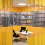 Temporary office space inside warehouses using curtain wall systems with yellow vinyl walls and clear PVC panels for visibility
