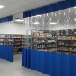 Blue vinyl Retail Storage & Clutter-Hiding Curtains with clear visibility panels used for product storage separation