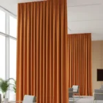 Echo Reducing Curtains dividing a large open lobby with tall windows for better sound absorption and privacy