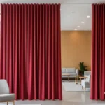 Echo Reducing Curtains in crimson red separating areas in a modern lounge to reduce echo and enhance comfort