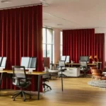 Red partition curtains for office sectioning modern work zones while adding color and privacy to the open floor plan.