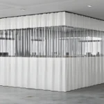 White insulated partition curtains for office creating a modular private meeting area with clear window panels.