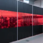 Black vinyl curtain with red vision panel creating a privacy-controlled fire station decontamination zone