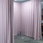 Blush curtain enclosure installed in a garage workspace for controlled project containment