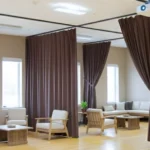 Brown fabric Curtains for Camps and Retreat Centers separating lounge and meeting spaces in a multipurpose hall