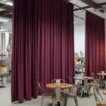 Burgundy curtain divider creating a private tasting area inside a small brewery taproom